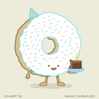 A donut dressed for a birthday party holding a piece of cake.