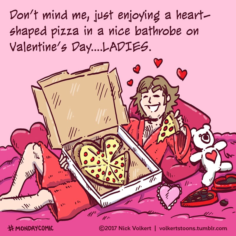A man in a robe with a heart-shaped pizza.
